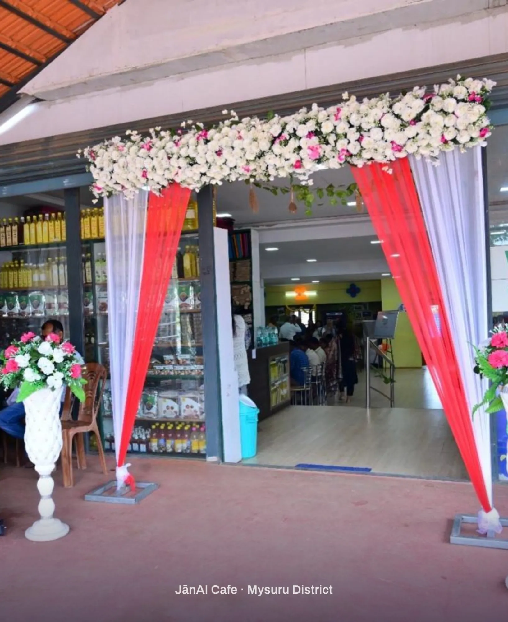 The flower-decked entrance of a JanAI Cafe in Mysuru District on its opening day
